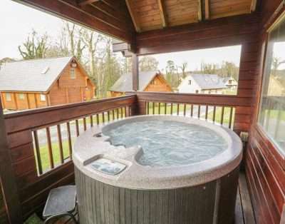 Timber retreat with hot tub at Sun View Lodge in Llanbedr near the Artro estuary and the dunes of Shell Island.