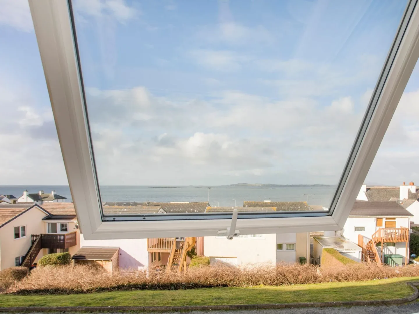 First-floor seaside apartment at Sandy Toes in Rhosneigr with views toward the west coast shoreline.