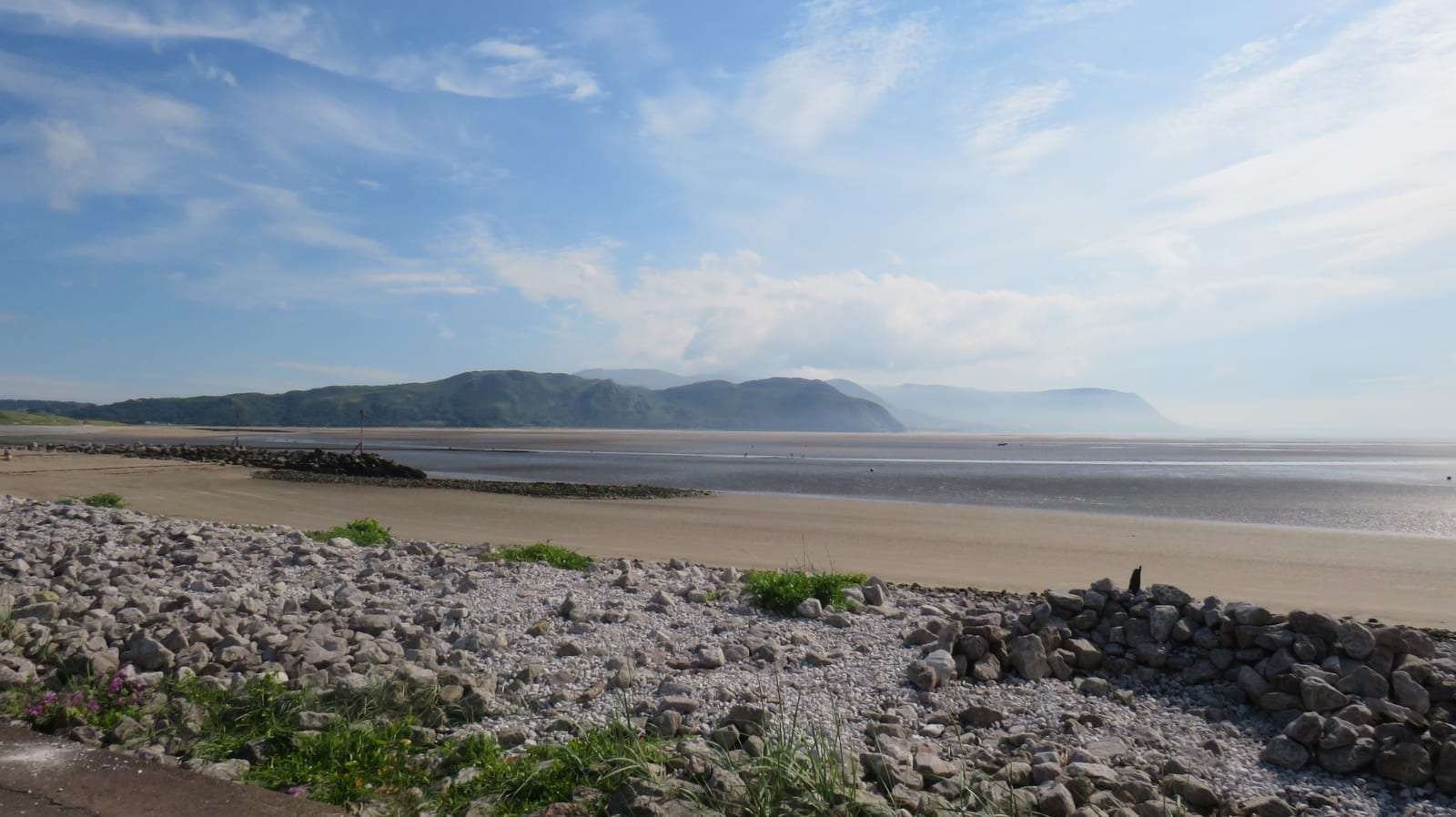 West Shore beach at Llandudno at low tide, looking across the sands to the Conwy mountains — a dog-friendly beach in North Wales