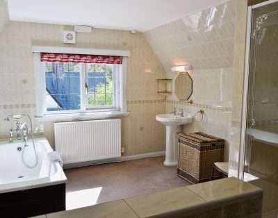 Family bathroom with a bath and shower at The Court, near Beaumaris, Anglesey