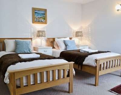 Twin bedroom with oak beds at The Court, near Beaumaris, Anglesey
