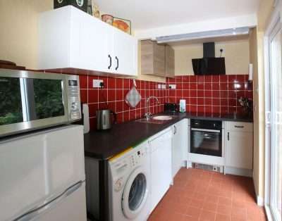 Kitchen with electric cooker, dishwasher and washing machine at The Garden House, near Monmouth