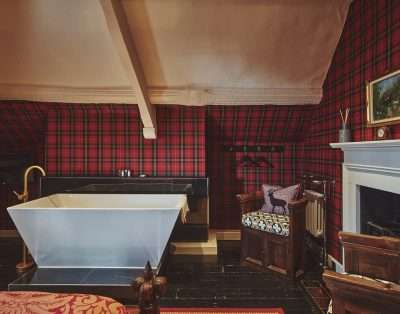 Tartan-walled bathroom with a freestanding bath at Valley Manor, Vale of Glamorgan