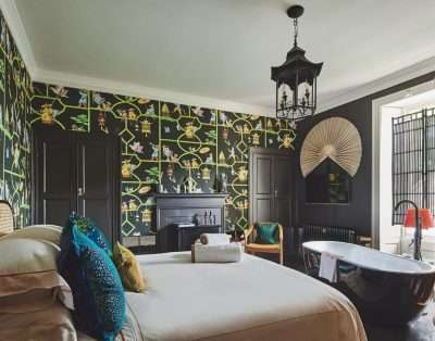 Dramatic bedroom with a black freestanding bath at Valley Manor, near Cowbridge