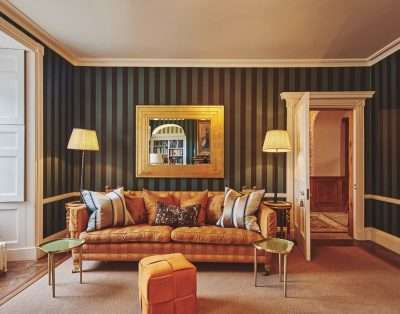 Green-striped sitting room with a gold mirror at Valley Manor, Vale of Glamorgan