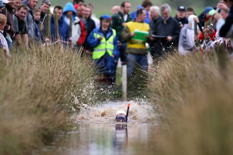 Competitor swimming through the Waen Rhydd peat bog at the World Bog Snorkelling Championship, Llanwrtyd Wells
