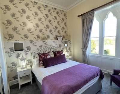 An individually decorated en-suite bedroom at Mellington Hall, Powys