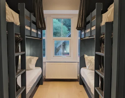 Four-bed room at Base Camp Snowdonia with bunk beds either side of a window