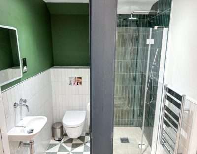 Shower room at Base Camp Snowdonia with a walk-in shower, toilet and basin